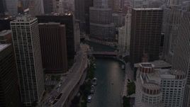 4.8K aerial stock footage of following the river toward base of Trump Tower at sunset, Downtown Chicago, Illinois Aerial Stock Footage | AX0003_037