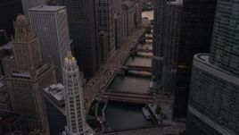 4.8K aerial stock footage of following the river between Mather Tower and Trump Tower at sunset, Downtown Chicago, Illinois Aerial Stock Footage | AX0003_038