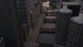 4.8K aerial stock footage of following the river through downtown past Marina City at sunset, Downtown Chicago, Illinois Aerial Stock Footage | AX0003_039