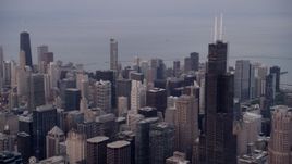 4.8K aerial stock footage flyby Willis Tower, reveal John Hancock Center in the distance, Downtown Chicago, Illinois, sunset Aerial Stock Footage | AX0003_043