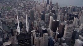 4.8K aerial stock footage of flying by Willis Tower spires, tilt down to Downtown Chicago buildings, Illinois, sunset Aerial Stock Footage | AX0003_046