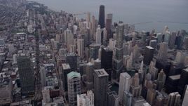 4.8K aerial stock footage of flying over Downtown Chicago to approach Trump International Hotel and Tower, at sunset, Illinois Aerial Stock Footage | AX0003_048