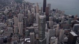 4.8K aerial stock footage pass Trump Tower Chicago to approach John Hancock Center in Downtown Chicago, at sunset, Illinois Aerial Stock Footage | AX0003_049