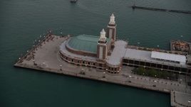 4.8K aerial stock footage of flying by the end of Navy Pier on a cloudy day at sunset, Chicago, Illinois Aerial Stock Footage | AX0003_067