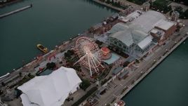 4.8K aerial stock footage tilt to Ferris wheel and amusement park rides on Navy Pier, at sunset, Chicago, Illinois Aerial Stock Footage | AX0003_068