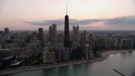 4.8K aerial stock footage of John Hancock Center and Downtown Chicago skyscrapers, on a cloudy day at twilight, Illinois Aerial Stock Footage | AX0003_069