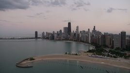 4.8K aerial stock footage approach North Avenue Beach and the skyline of Downtown Chicago, on a cloudy day at twilight, Illinois Aerial Stock Footage | AX0003_073