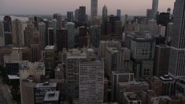 4.8K aerial stock footage of flying by Downtown Chicago skyscrapers at sunset, Illinois Aerial Stock Footage | AX0003_077