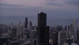 4.8K aerial stock footage of an orbit of the top of Willis Tower on a cloudy day at sunset, Chicago, Illinois Aerial Stock Footage | AX0003_085