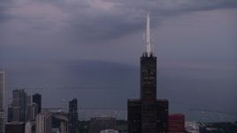 4.8K aerial stock footage of orbiting around the top of Willis Tower, Downtown Chicago, Illinois, sunset Aerial Stock Footage | AX0003_086