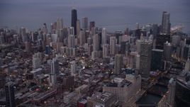 4.8K aerial stock footage of flying by Downtown Chicago on a hazy sunset, Illinois Aerial Stock Footage | AX0003_087