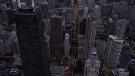 4.8K aerial stock footage of following N Michigan Avenue past Downtown Chicago buildings, at twilight, Illinois Aerial Stock Footage | AX0003_097