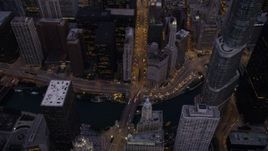 4.8K aerial stock footage bird's eye of following N Michigan Avenue over the bridge spanning the the Chicago River, at twilight, Downtown Chicago, Illinois Aerial Stock Footage | AX0003_099