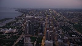 4.8K aerial stock footage bird's eye view of N Michigan Avenue by Grant Park, and tilt to South Chicago at twilight, Illinois Aerial Stock Footage | AX0003_102