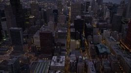 4.8K aerial stock footage tilt from S Clark Street through Downtown Chicago, revealing skyscrapers at twilight, Illinois Aerial Stock Footage | AX0003_103