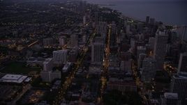4.8K aerial stock footage tilt from N Clark Street and follow it north through Downtown Chicago, Illinois, twilight Aerial Stock Footage | AX0003_111