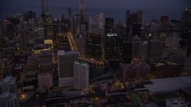 4.8K aerial stock footage tilt from train station to Chicago River and skyscrapers, Downtown Chicago, Illinois, twilight Aerial Stock Footage | AX0003_115