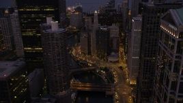 4.8K aerial stock footage fly over bridges and follow the Chicago River through downtown at twilight, Downtown Chicago, Illinois Aerial Stock Footage | AX0003_118