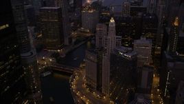 4.8K aerial stock footage of following the Chicago River over bridges in Downtown Chicago, Illinois, twilight Aerial Stock Footage | AX0003_119