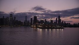 4.8K aerial stock footage of flying by Navy Pier with the Downtown Chicago skyline in the background at twilight, Illinois Aerial Stock Footage | AX0003_128