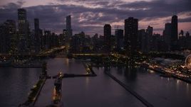 4.8K aerial stock footage of an approach to the Chicago River and downtown skyscrapers, Illinois, twilight Aerial Stock Footage | AX0003_130