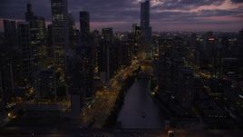 4.8K aerial stock footage tilt to reveal and approach the bridge at the mouth of the Chicago River in Downtown Chicago, Illinois, twilight Aerial Stock Footage | AX0003_131