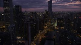 4.8K aerial stock footage follow Chicago River through downtown toward Trump Tower Chicago at twilight, Illinois Aerial Stock Footage | AX0003_132