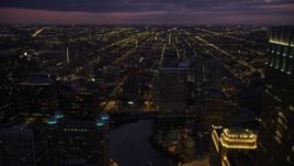 4.8K aerial stock footage of flying over the Riverbend condo high-rise by the Chicago River at twilight, approach West Chicago, Downtown Chicago, Illinois Aerial Stock Footage | AX0003_136