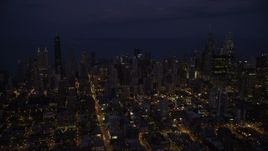 4.8K aerial stock footage of passing by Downtown Chicago cityscape at night, Illinois Aerial Stock Footage | AX0003_139