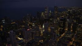 4.8K aerial stock footage of flying over Downtown Chicago toward Aon Center and Trump International at night, Illinois Aerial Stock Footage | AX0003_143