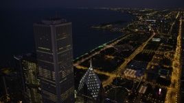 4.8K aerial stock footage of flying by Two Prudential Plaza and Aon Center to approach Grant Park at night, Downtown Chicago, Illinois Aerial Stock Footage | AX0003_145