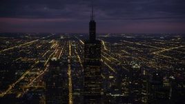 4.8K aerial stock footage of orbiting Willis Tower on a cloudy night, Downtown Chicago, Illinois Aerial Stock Footage | AX0003_147