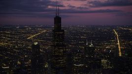 4.8K aerial stock footage of an orbit of Willis Tower, on a cloudy day at night, Downtown Chicago, Illinois Aerial Stock Footage | AX0003_148