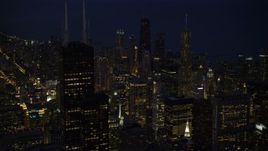 4.8K aerial stock footage approach Willis Tower and Downtown Chicago skyscrapers at night, and tilt down, Illinois Aerial Stock Footage | AX0003_154