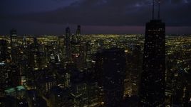 4.8K aerial stock footage of Downtown Chicago cityscape and John Hancock Center, at night with clouds, Illinois Aerial Stock Footage | AX0003_160