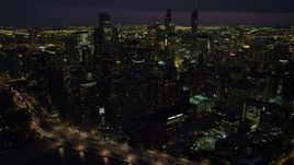 4.8K aerial stock footage of flying by Downtown Chicago cityscape, at night with clouds, Illinois Aerial Stock Footage | AX0003_161