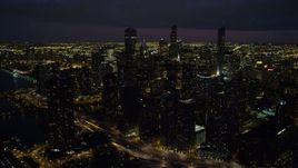 4.8K aerial stock footage of flying by Downtown Chicago on a cloudy night, Illinois Aerial Stock Footage | AX0003_162