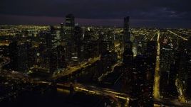 4.8K aerial stock footage of flying by Downtown Chicago at night, revealing the Chicago River, Illinois Aerial Stock Footage | AX0003_163