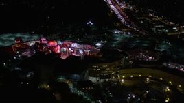 5K aerial stock footage of approaching Universal Studios Hollywood at night, California Aerial Stock Footage | AX0004_007E