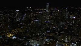 5K aerial stock footage tilt to reveal Downtown Los Angeles skyscrapers at night, California Aerial Stock Footage | AX0004_027E