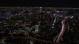 5K aerial stock footage tilt up to reveal and approach Downtown Los Angeles at night, California Aerial Stock Footage | AX0004_038E