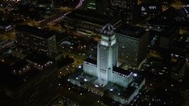 5K aerial stock footage of approaching and orbiting Los Angeles City Hall at night in Downtown Los Angeles, California Aerial Stock Footage | AX0004_064E