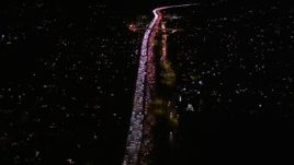 5K aerial stock footage fly over traffic on Interstate 405 by Westwood at night, California Aerial Stock Footage | AX0004_092E
