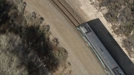 5K aerial stock footage of tracking the front of a commuter train in Santa Clarita, California Aerial Stock Footage | AX0005_027