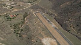 5K aerial stock footage orbit runways at a desert airfield in Agua Dulce, California Aerial Stock Footage | AX0005_048