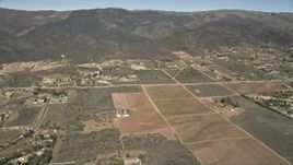 5K aerial stock footage fly over arid rural homes and fields in Mojave Desert, California Aerial Stock Footage | AX0005_049