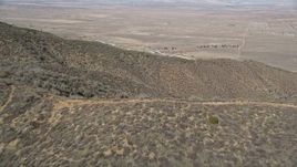 5K aerial stock footage fly over mountain ridges to approach California Aqueduct in the Mojave Desert Aerial Stock Footage | AX0005_057E