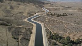 5K aerial stock footage of following the California Aqueduct by mountains in Mojave Desert, California Aerial Stock Footage | AX0005_061E