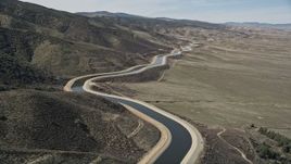 5K aerial stock footage fly low over the desert to reveal California Aqueduct in Mojave Desert Aerial Stock Footage | AX0005_063