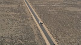 5K aerial stock footage orbit a big rig and SUV on a desert road in Antelope Valley Aerial Stock Footage | AX0005_075